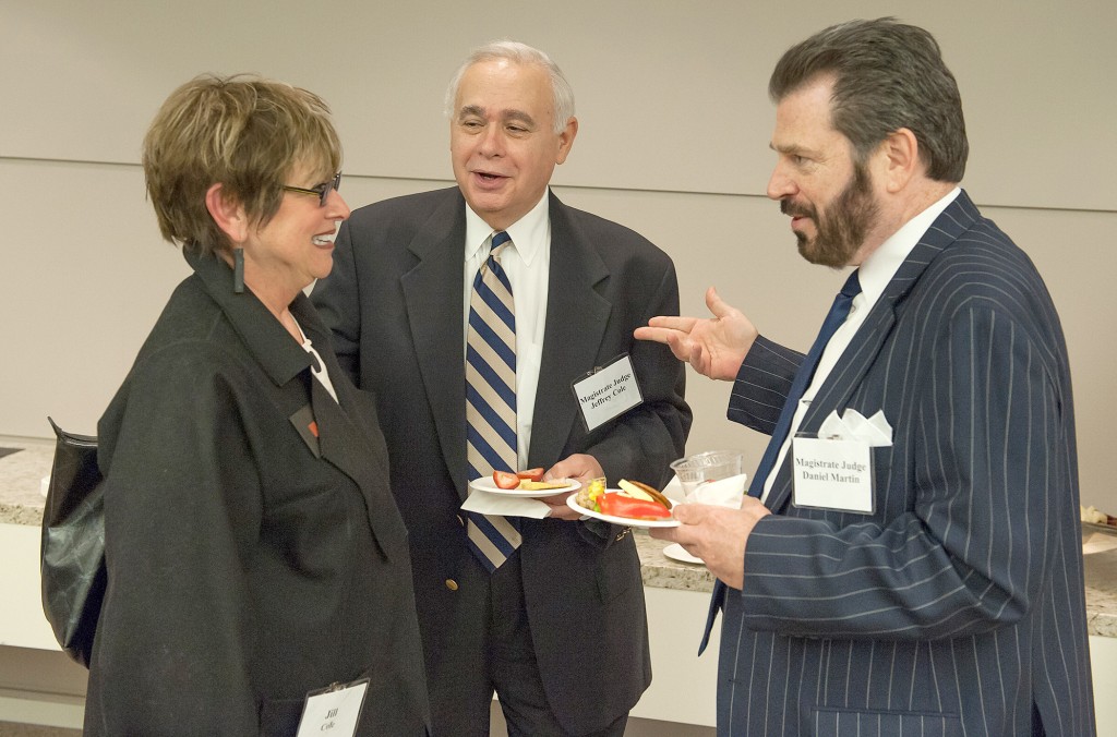 U.S. Magistrate Judge Daniel G. Martin (right) and Jeffrey Cole enjoy hors d'oeuvres as they greet Cole's wife, Jill,